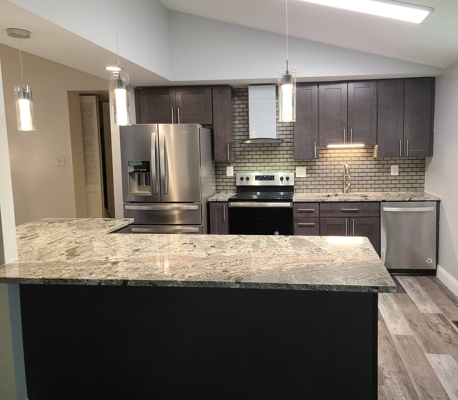 Renovated kitchen with dark cabinetry and granite island, District Heights, MD
